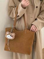 Solid Color Handbag with Plush Charm