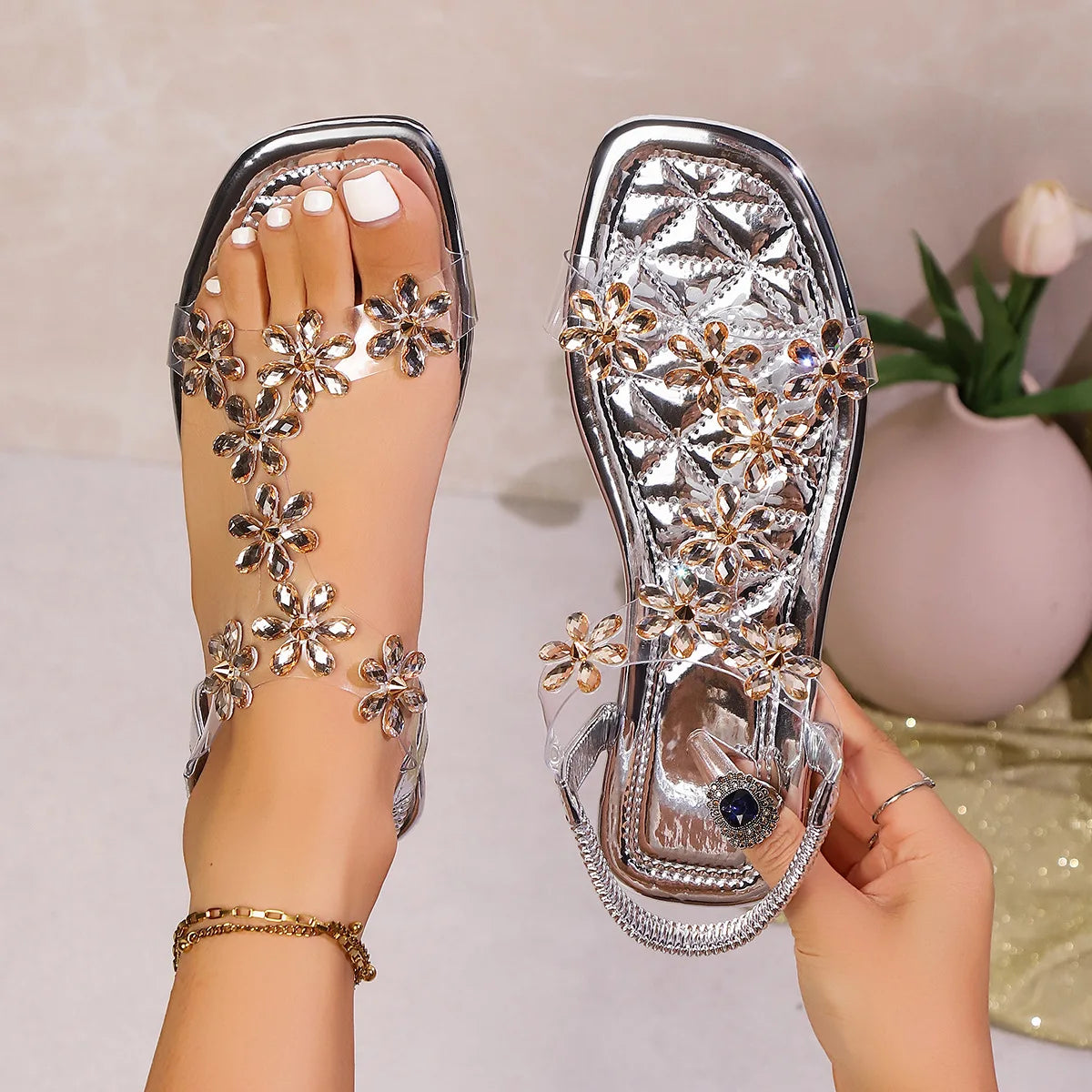 A pair of women's square-toe flat sandals, stylish silver sandals adorned with floral decorations 2026