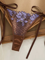 A limited edition brown and purple lace lingerie set with rose embroidery, see-through netting bra, and tie-up thong ZA825200
