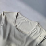 Women's long sleeved yoga suit sports top, high-end tight fitting hollow back fixed chest cushion