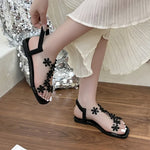 A pair of women's square-toe flat sandals, stylish silver sandals adorned with floral decorations 2026