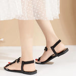 A pair of women's square-toe flat sandals, stylish silver sandals adorned with floral decorations 2026