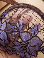 A limited edition brown and purple lace lingerie set with rose embroidery, see-through netting bra, and tie-up thong ZA825200